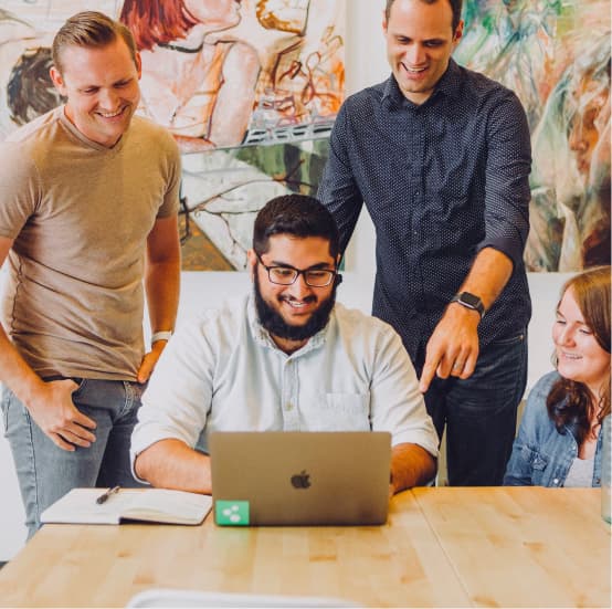 People pointing at computer